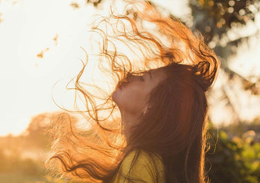 Lady with healthy hair, outside in the sun